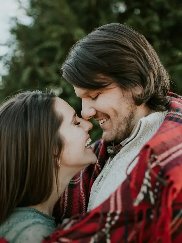 A couple laughing together outdoors