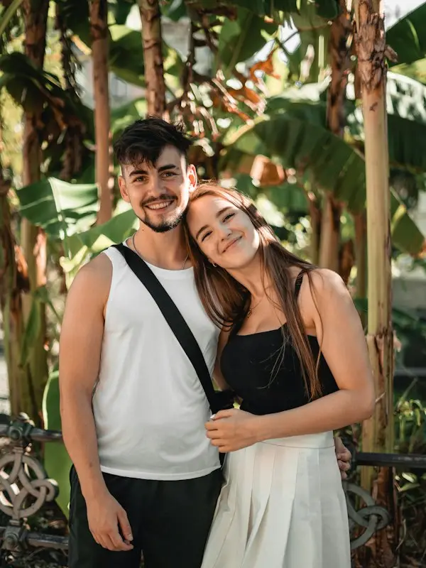 A smiling couple posing in a garden in Milan