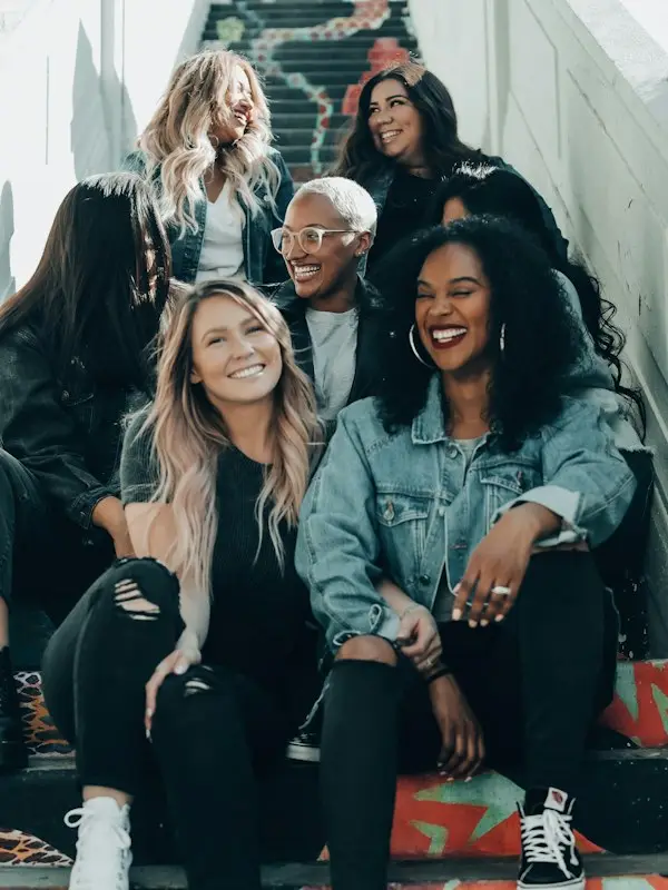 A group of friends laughing on city stairs