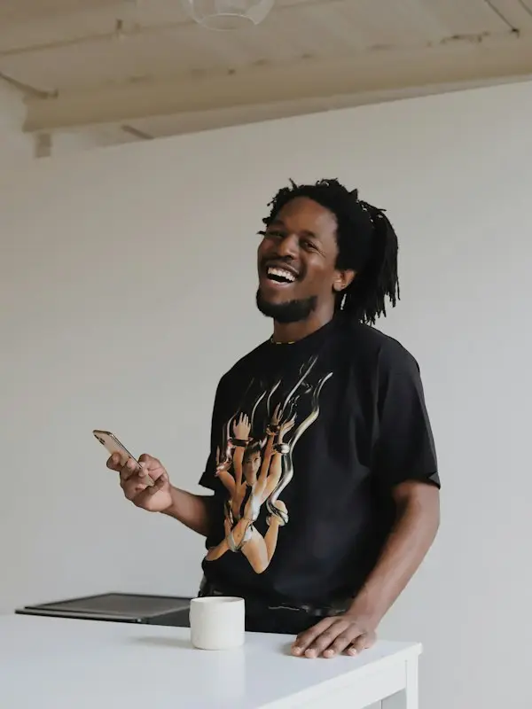 Man laughing while holding his phone