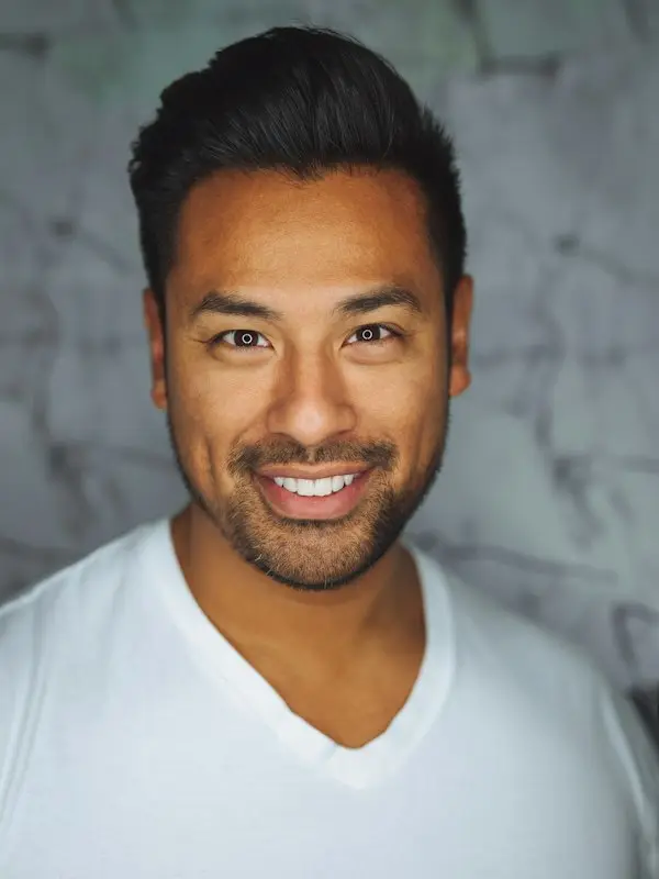 Man in a white T-shirt smiling