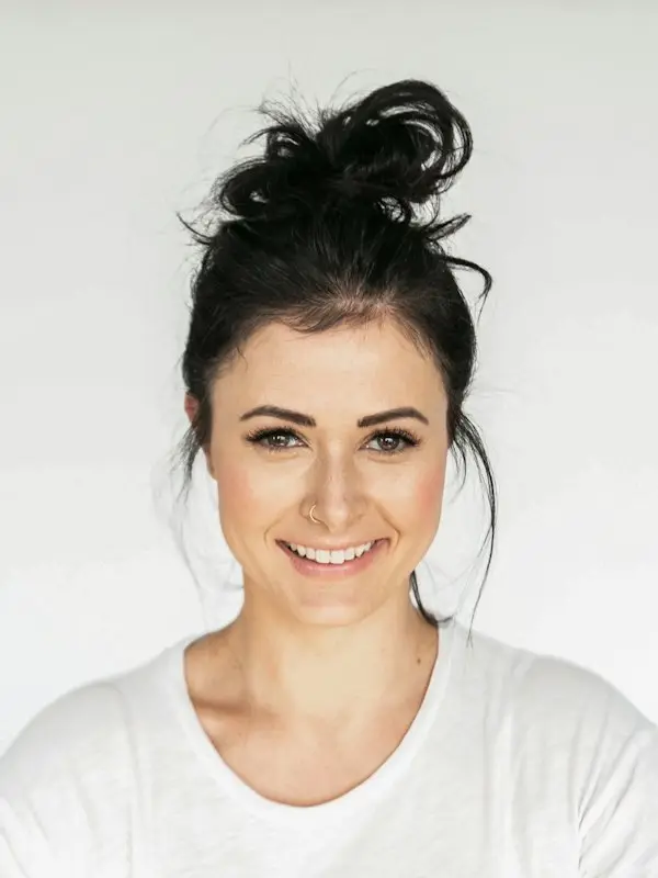Smiling woman with her hair in a bun
